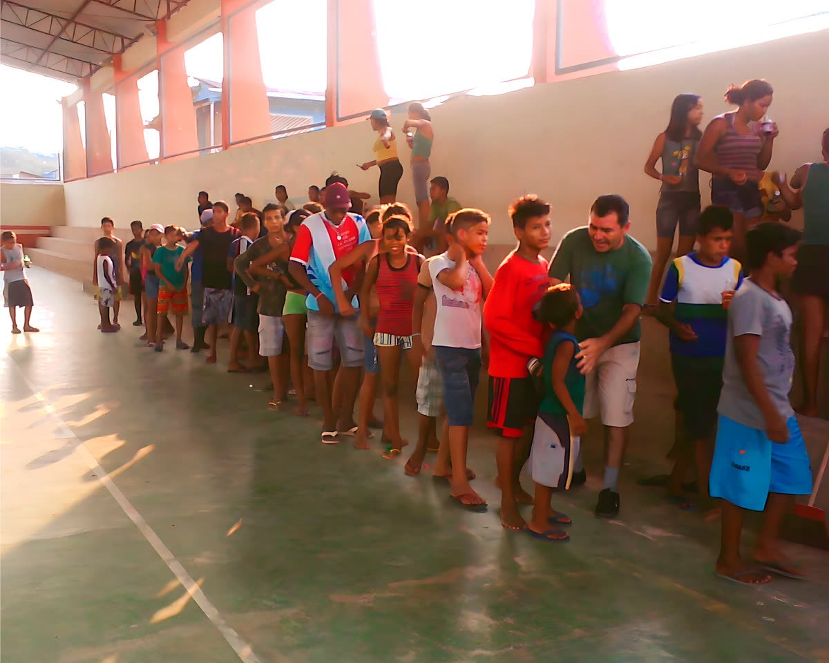 Fila de crianças e adolescentes em uma quadra coberta, com um educador ao lado